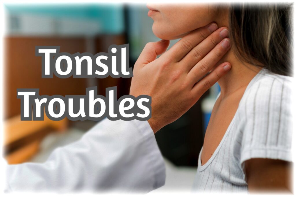 Doctor checking tonsils of a patient.